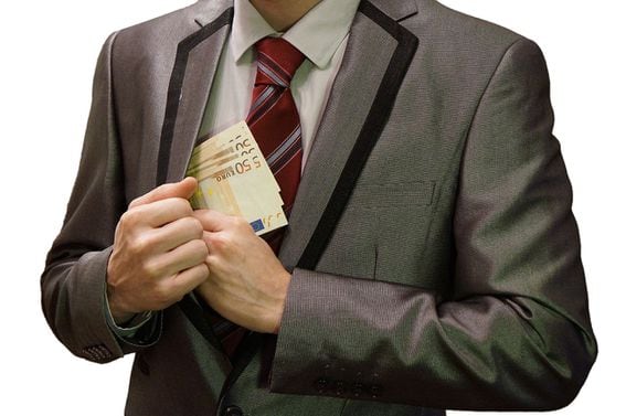 Corrupt man in a suit putting euro banknotes into his pocket. White background. This photo has been released into the public domain. There are no copyrights: you can use and modify this photo without asking, and without attribution. (Kiwiev)