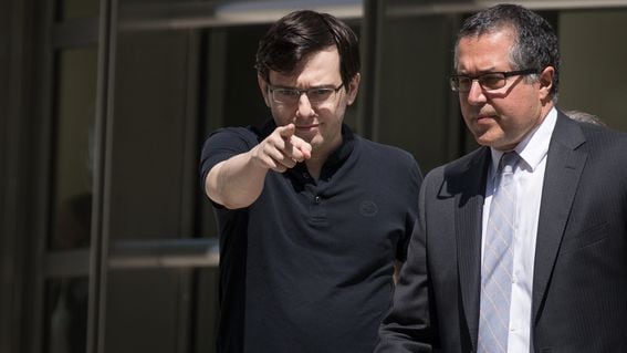 Former pharmaceutical executive Martin Shkreli on the left points as he exits a courthouse (Drew Angerer/Getty Images)