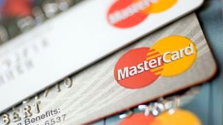 Mastercard logos appear on credit cards arranged for a photo