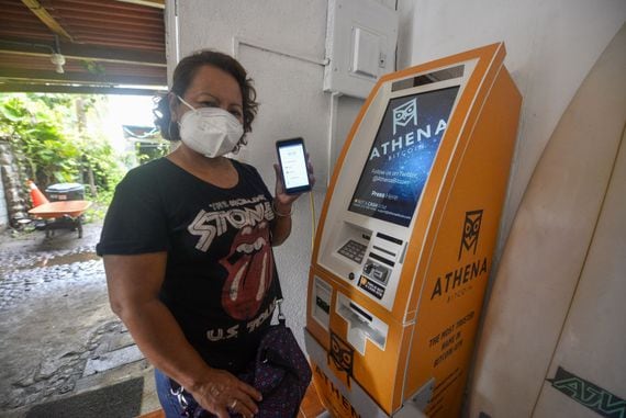 A woman holds up a phone displaying a bitcoin wallet on June 16, 2021 in Chiltuipan, El Salvador. Though sometimes affiliated with the Western far right, Bitcoin has been embraced across a broad political spectrum. (Camilo Freedman/Getty Images)