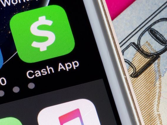 CASH app on Smartphone next to $100 dollar bill (Shutterstock)