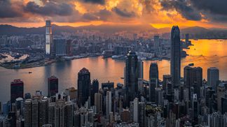 Sunrise over Victoria Harbor in Hong Kong cityscape (Unsplash)