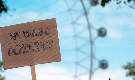 we demand democracy protest sign (Fred Moon/Unsplash, modified by CoinDesk)