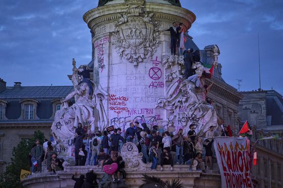 PARIS, FRANCE - JULY 07: People are seen celebrating on the statue of Marianne on the Place de la Republique to celebrate after the Nouveau Front Populaire, an alliance of left wing parties including the far-left wing party, La France Insoumise came in first on July 07, 2024 in Paris, France. The National Rally party was expected to have a strong showing in the second round of France's legislative election, which was called by the French president last month after his party performed poorly in the European election, but first projections have shown an unexpected lead for French left wing alliance New Popular Front. (Photo by Remon Haazen/Getty Images)