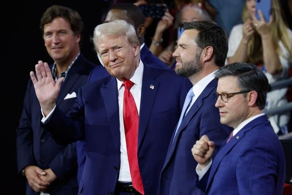 MILWAUKEE, WISCONSIN - JULY 15: (L-R) Tucker Carlson, U.S. Rep. Byron Donalds (R-FL), Republican presidential candidate, former U.S. President Donald Trump,  Republican Vice Presidential candidate, U.S. Sen. J.D. Vance (R-OH), and Speaker of the House Mike Johnson (R-LA) appear on the first day of the Republican National Convention at the Fiserv Forum on July 15, 2024 in Milwaukee, Wisconsin. Delegates, politicians, and the Republican faithful are in Milwaukee for the annual convention, concluding with former President Donald Trump accepting his party's presidential nomination. The RNC takes place from July 15-18. (Photo by Chip Somodevilla/Getty Images)